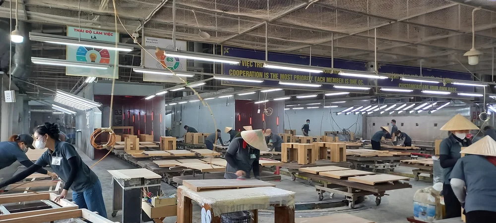 Inside a furniture factory in Vietnam during a Cosmo Sourcing client visit