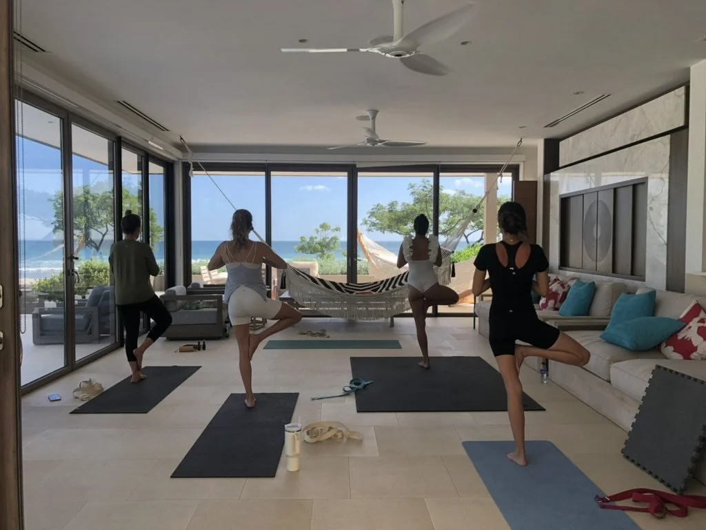 Britt teaching a private yoga session on the beach.