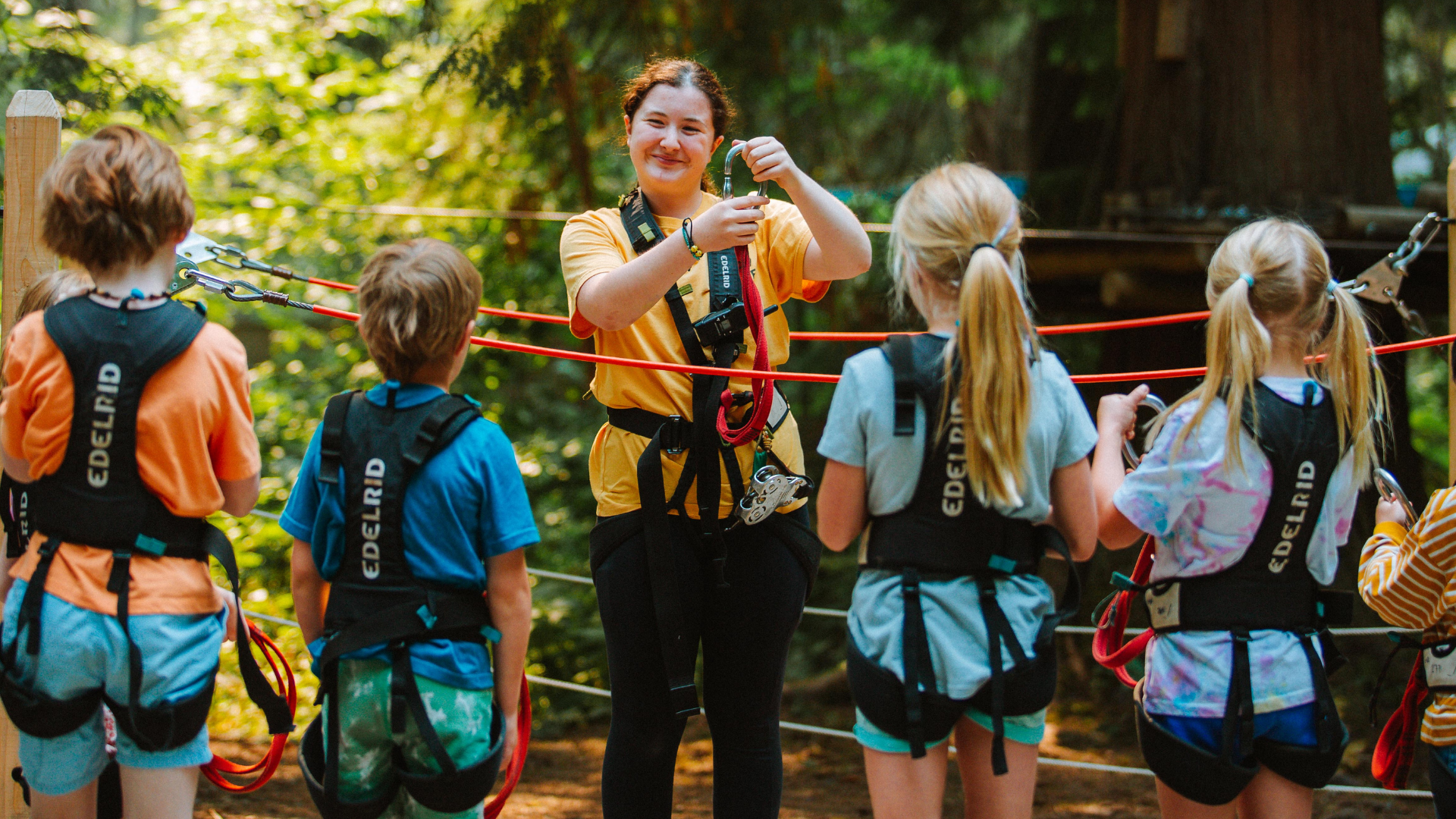 A WildPlay guide briefing a group of students before the course