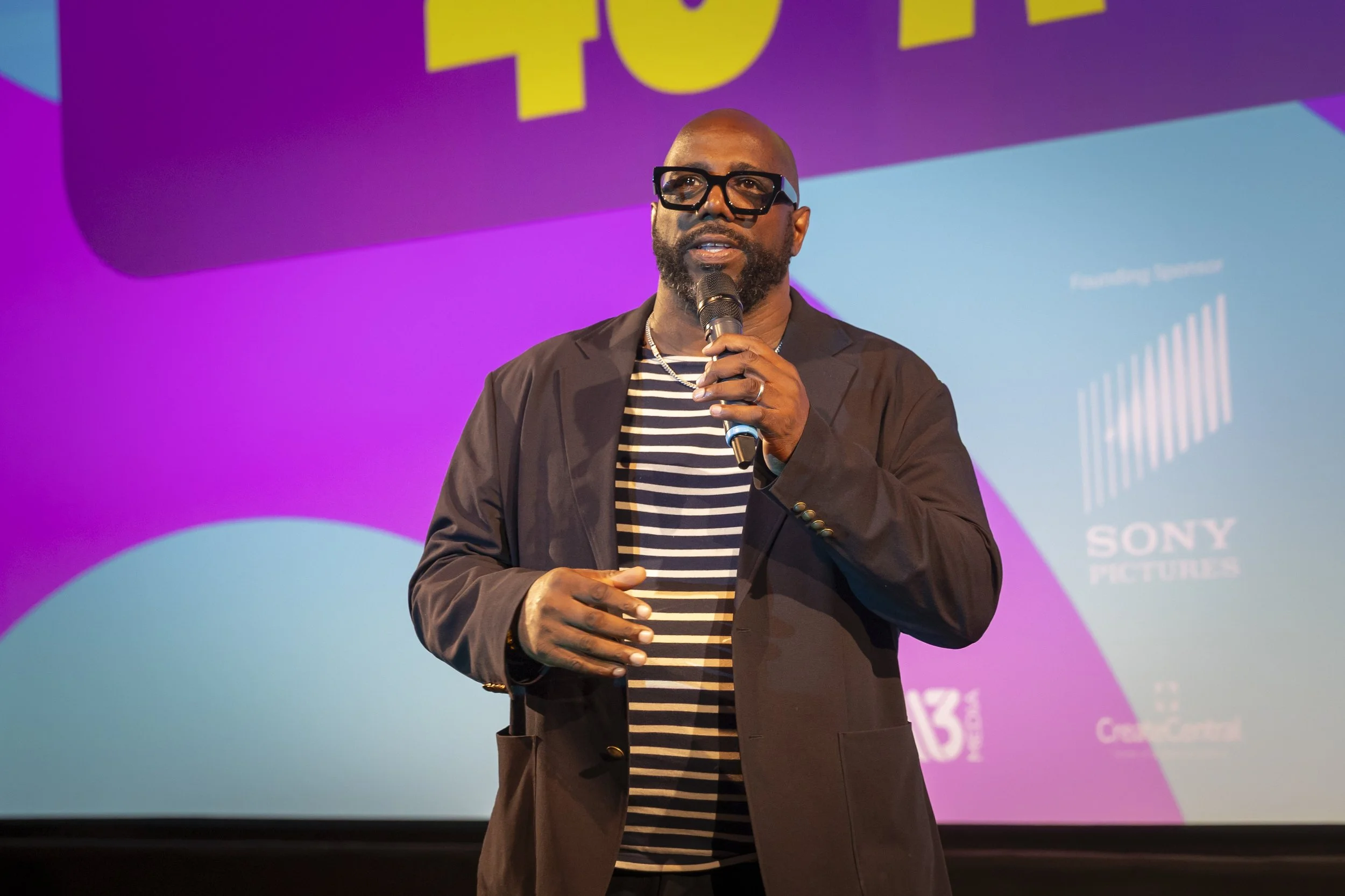 Iyare Igiehon on stage with a microphone at S.O.U.L. Fest 2025.