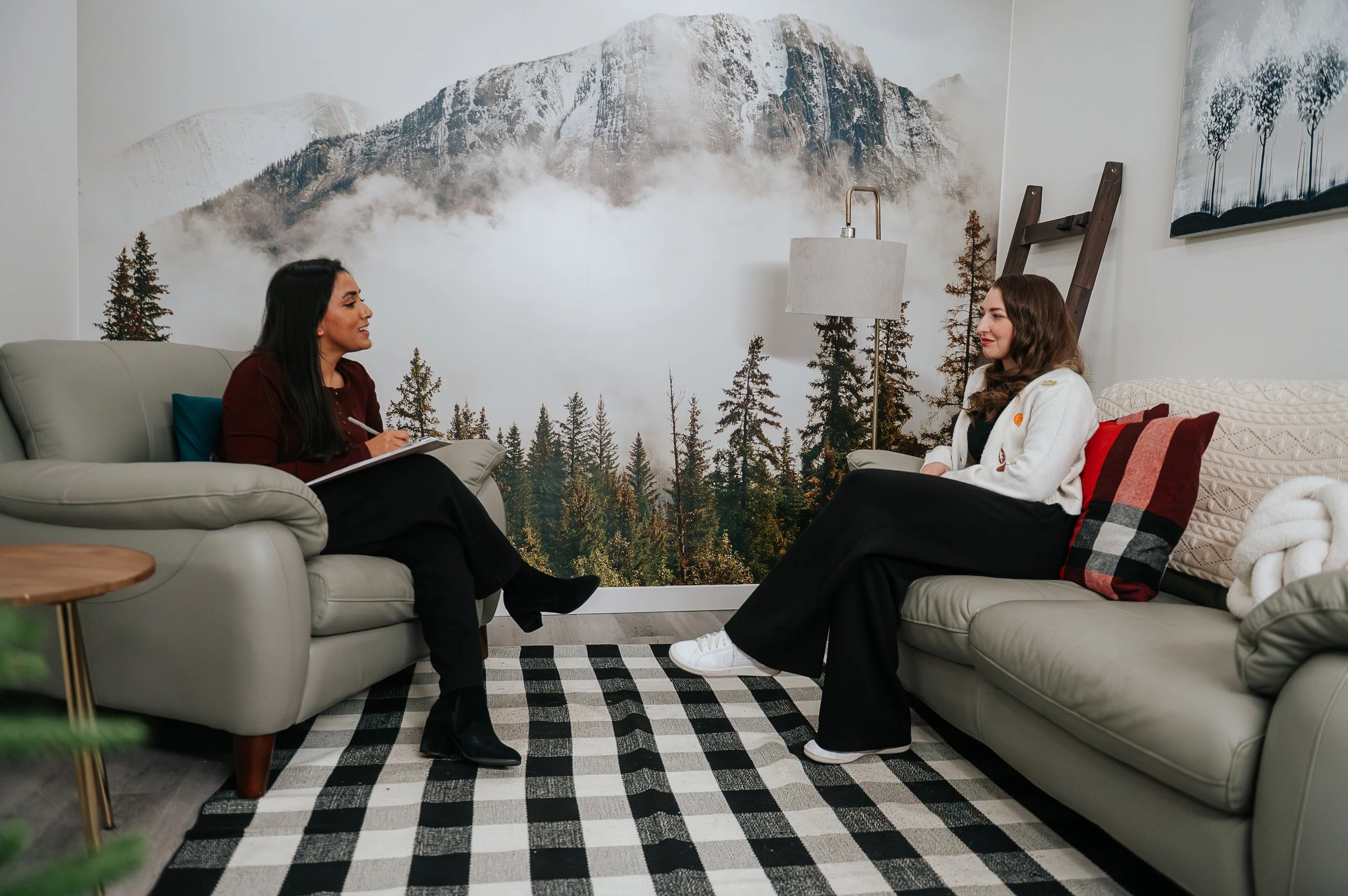 A therapy session at Summit Counselling Services in Edmonton — two people in conversation in a warm, welcoming office