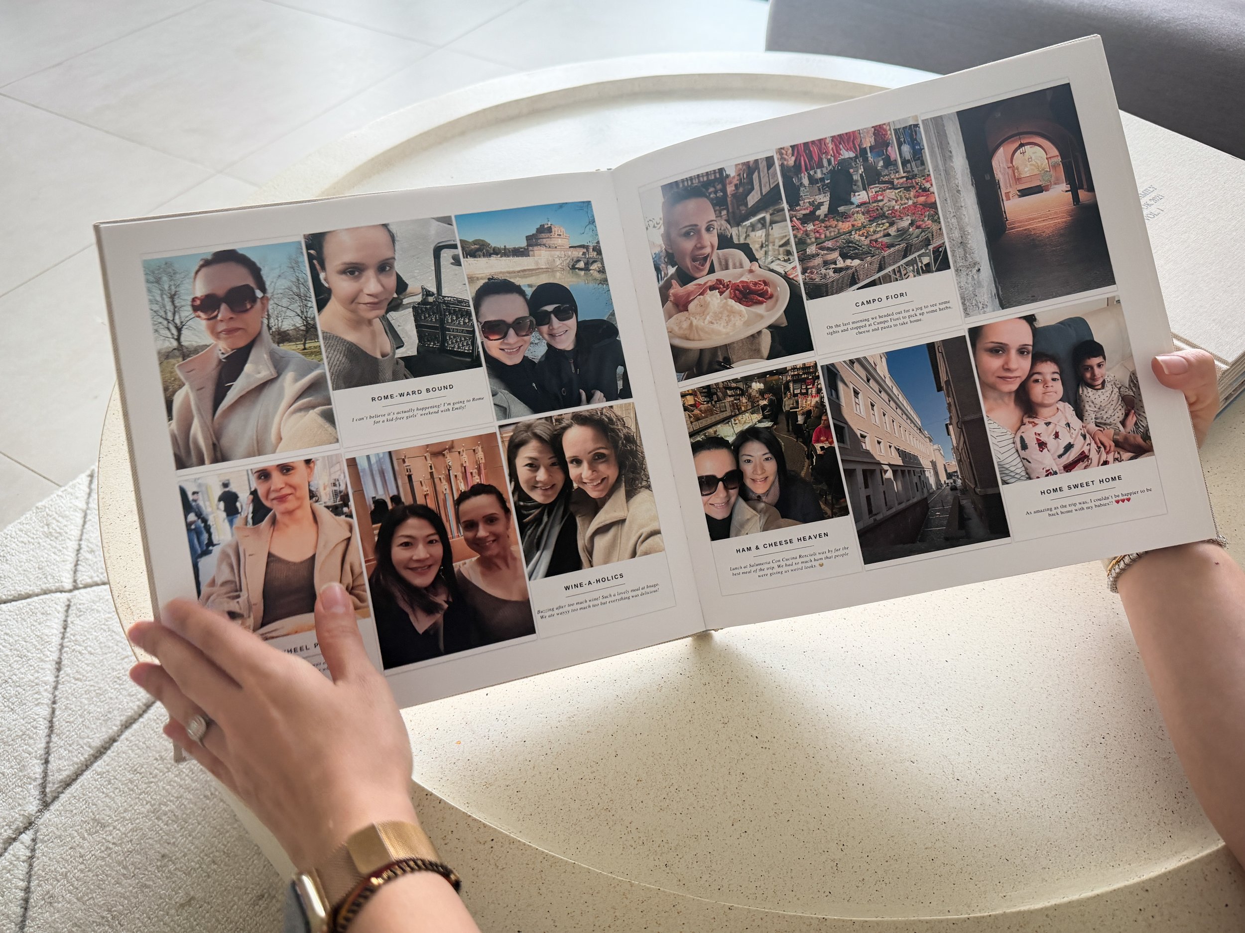 Finished printed family photo book held open showing a completed memory keeping spread