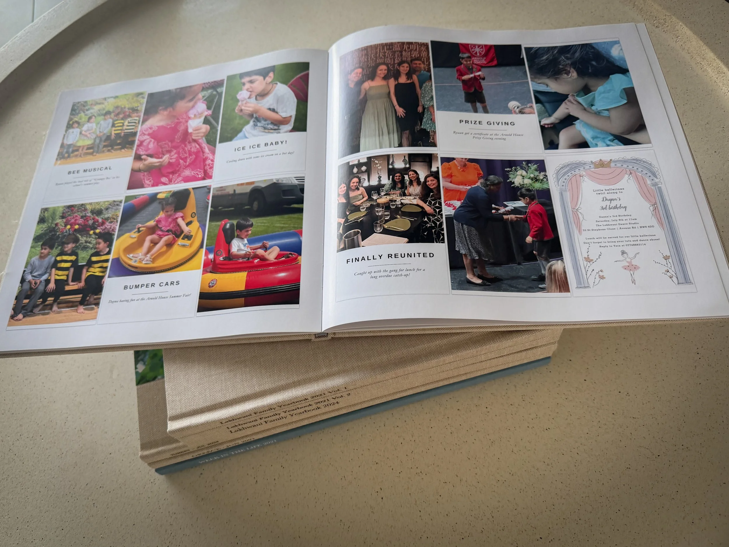 Printed family memory keeping books stacked on a linen surface