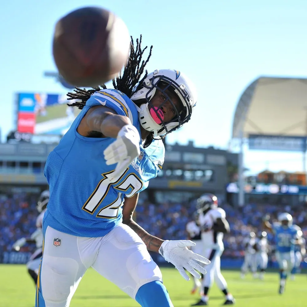 Professional football player reaching toward the camera during warmups