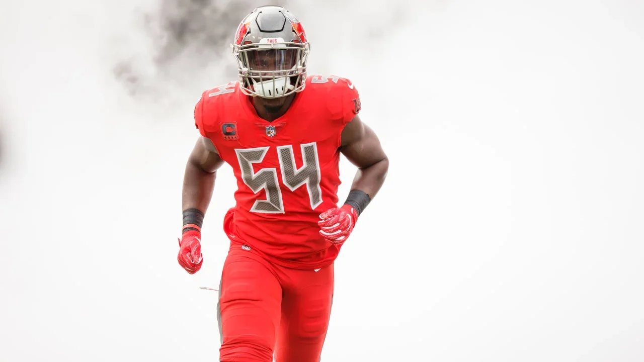 NFL linebacker in a red uniform entering the field
