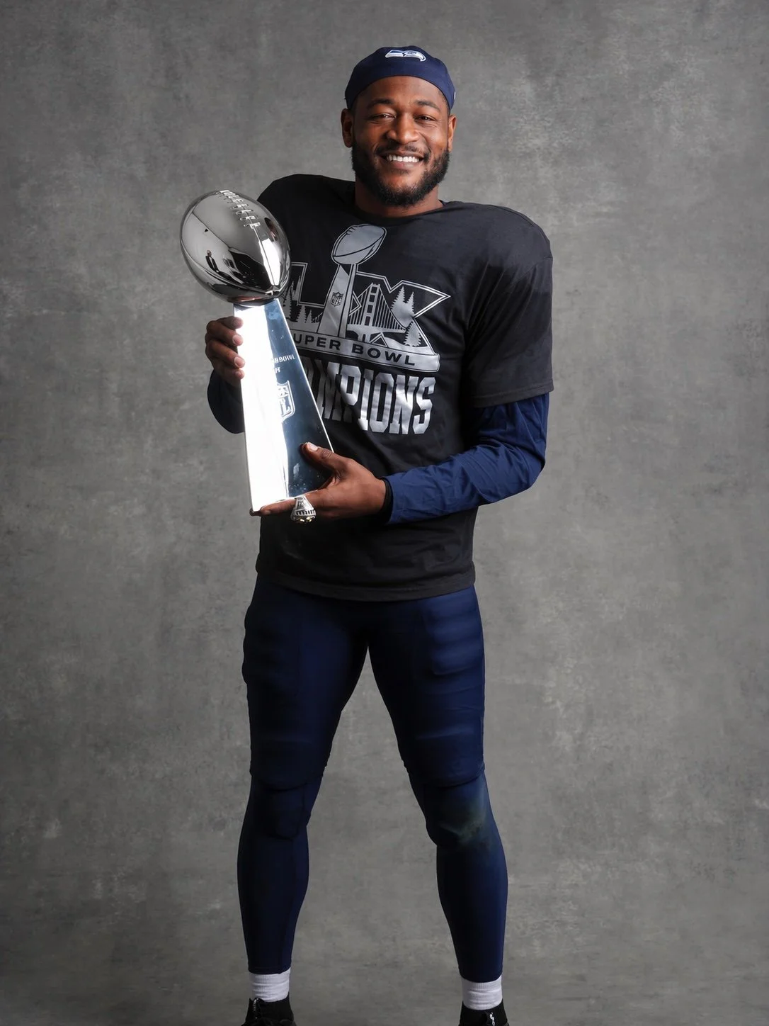 Super Bowl champion holding the Lombardi Trophy