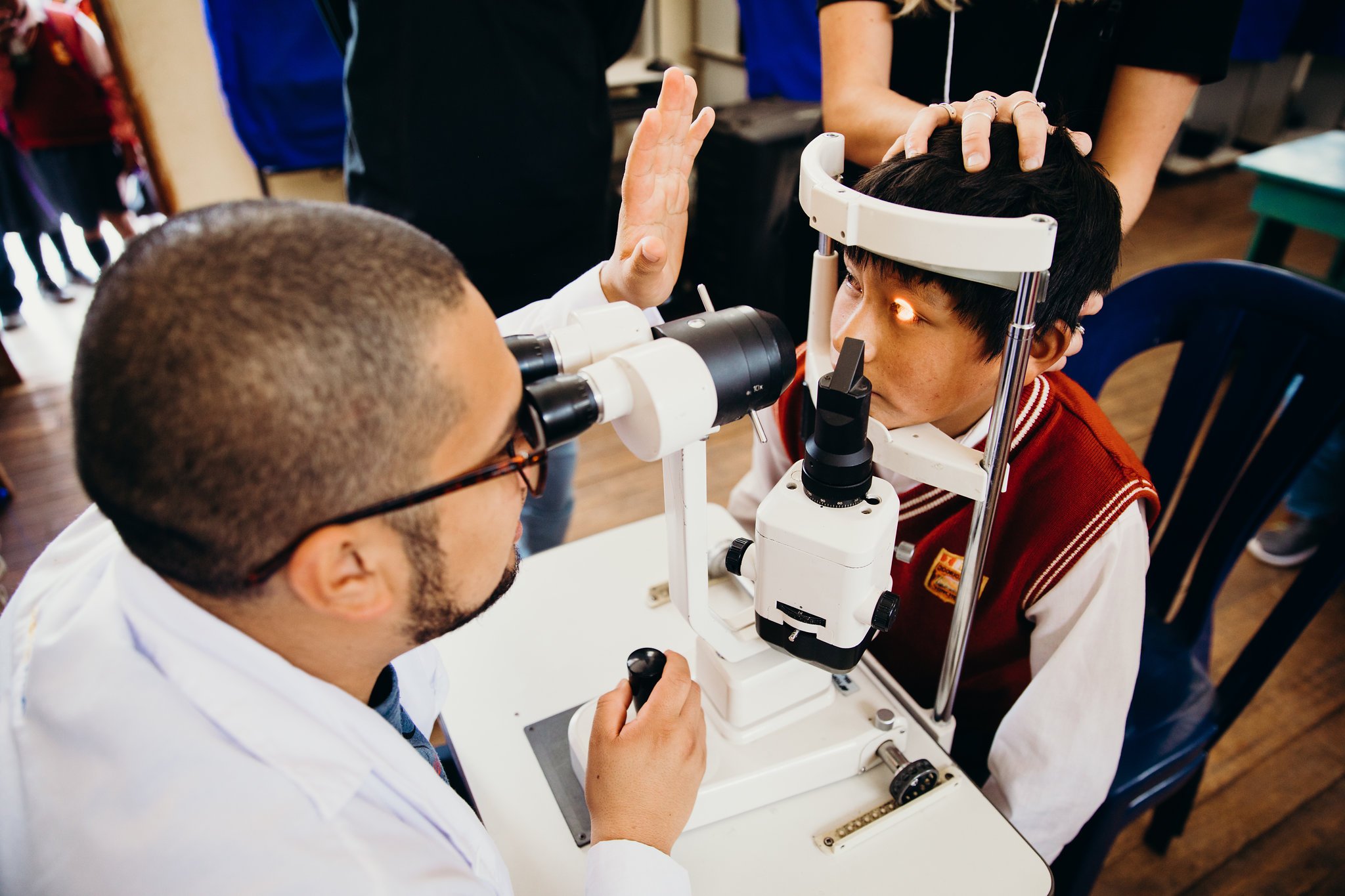 A patient having their eye health examined by eye machinery