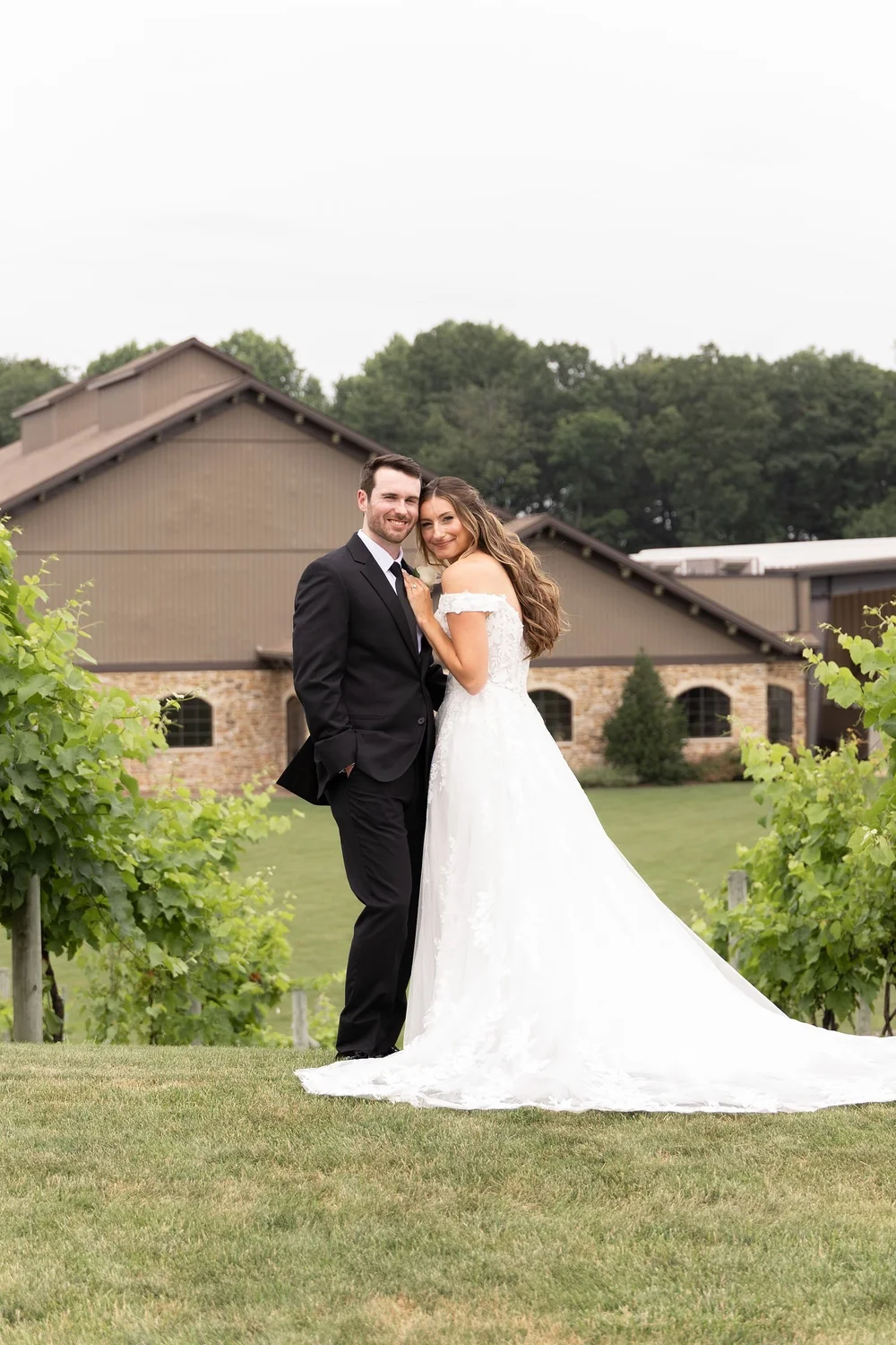 Couple in the vineyard in front of the Folino Estate winery building