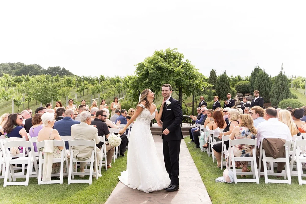 Ceremony at the Folino gazebo with guests in white chairs