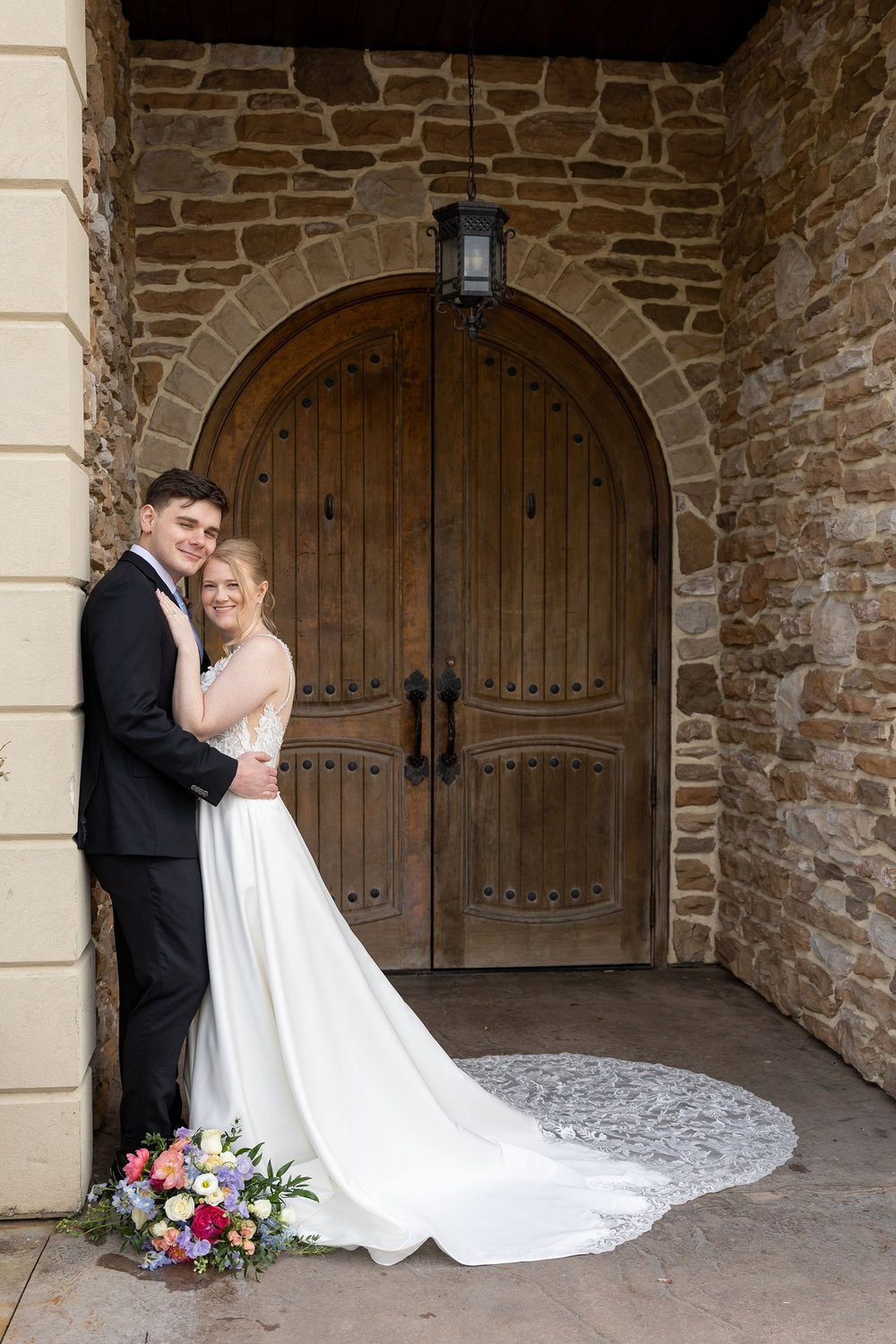 Couple at the arched wooden door of the Folino winery