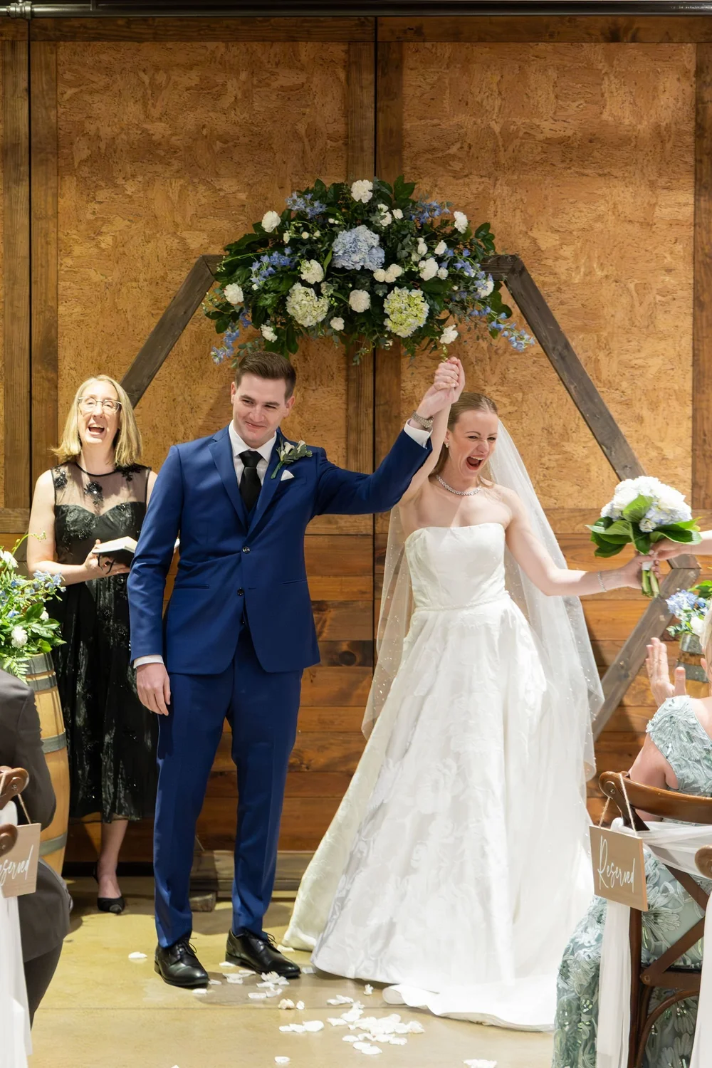 Couple celebrating at the end of their indoor ceremony at Folino