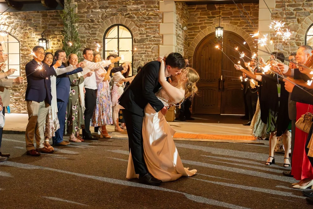 Groom dipping the bride during the sparkler send-off