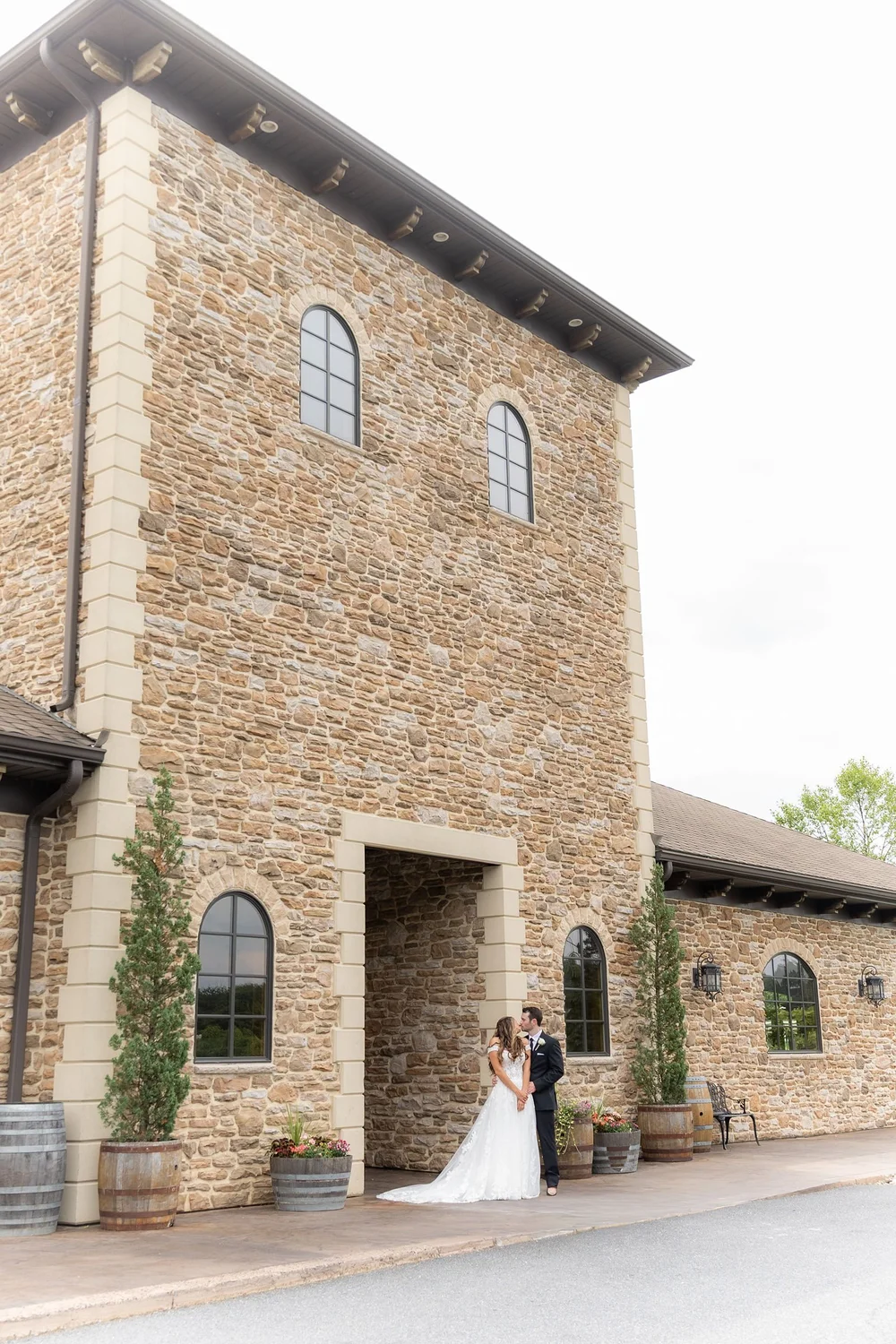 Couple beside the stone tower of the Folino Estate winery