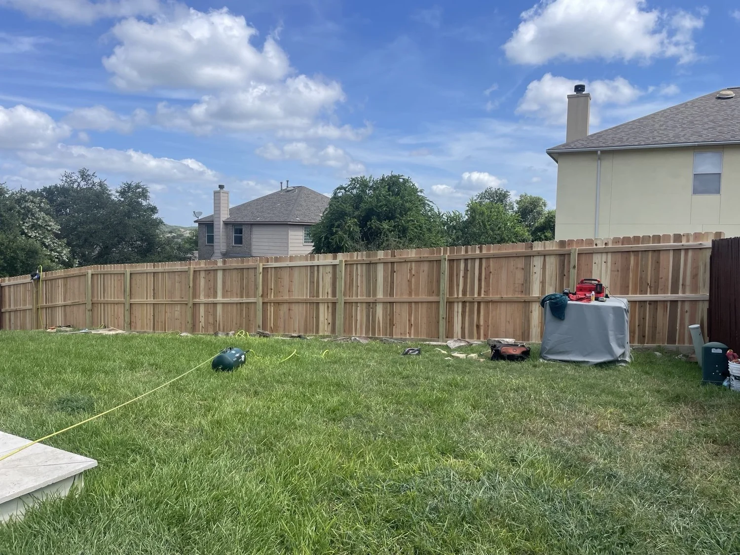 Cedar rails, pressure-treated posts and bottom kickboard during the Stone Oak fence installation