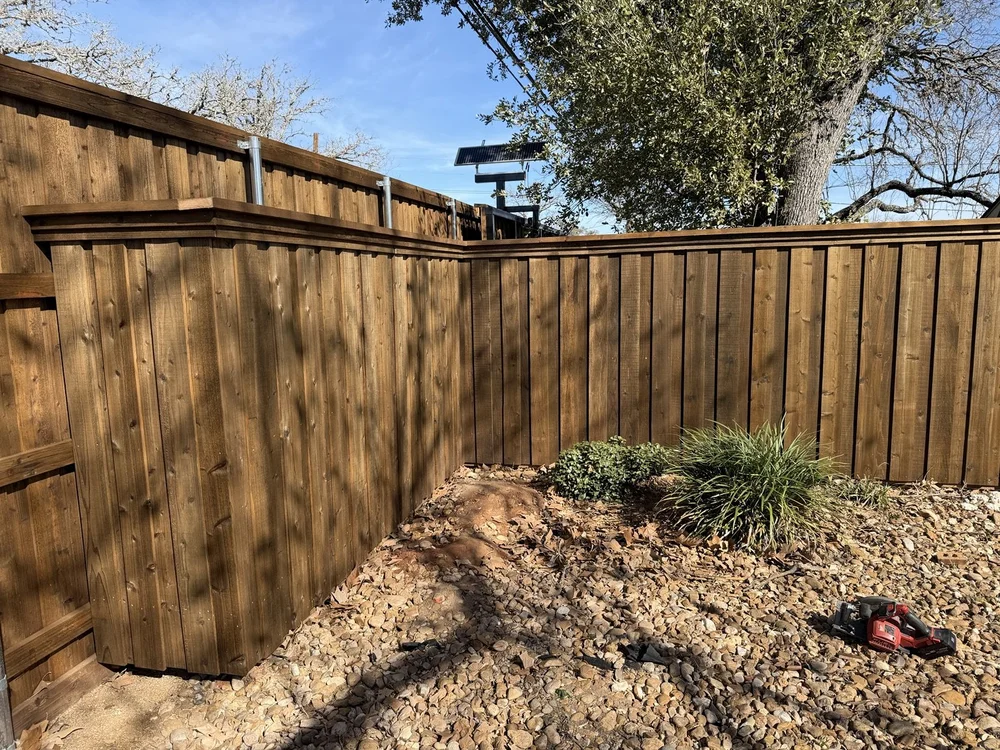 Board-on-board fence corner with top cap and trim at the Fredericksburg rental