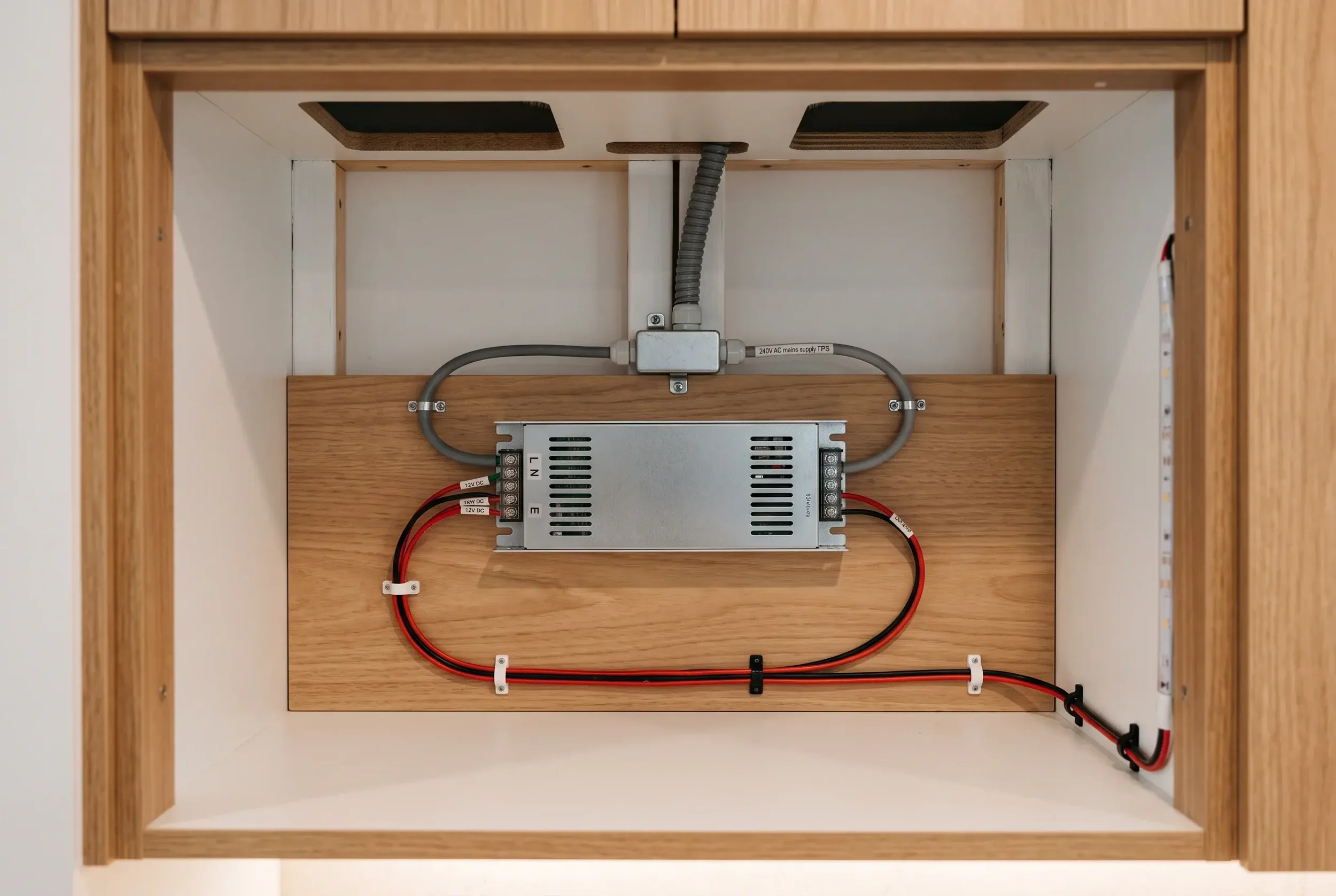 Accessible LED driver installed in a ventilated cabinet void