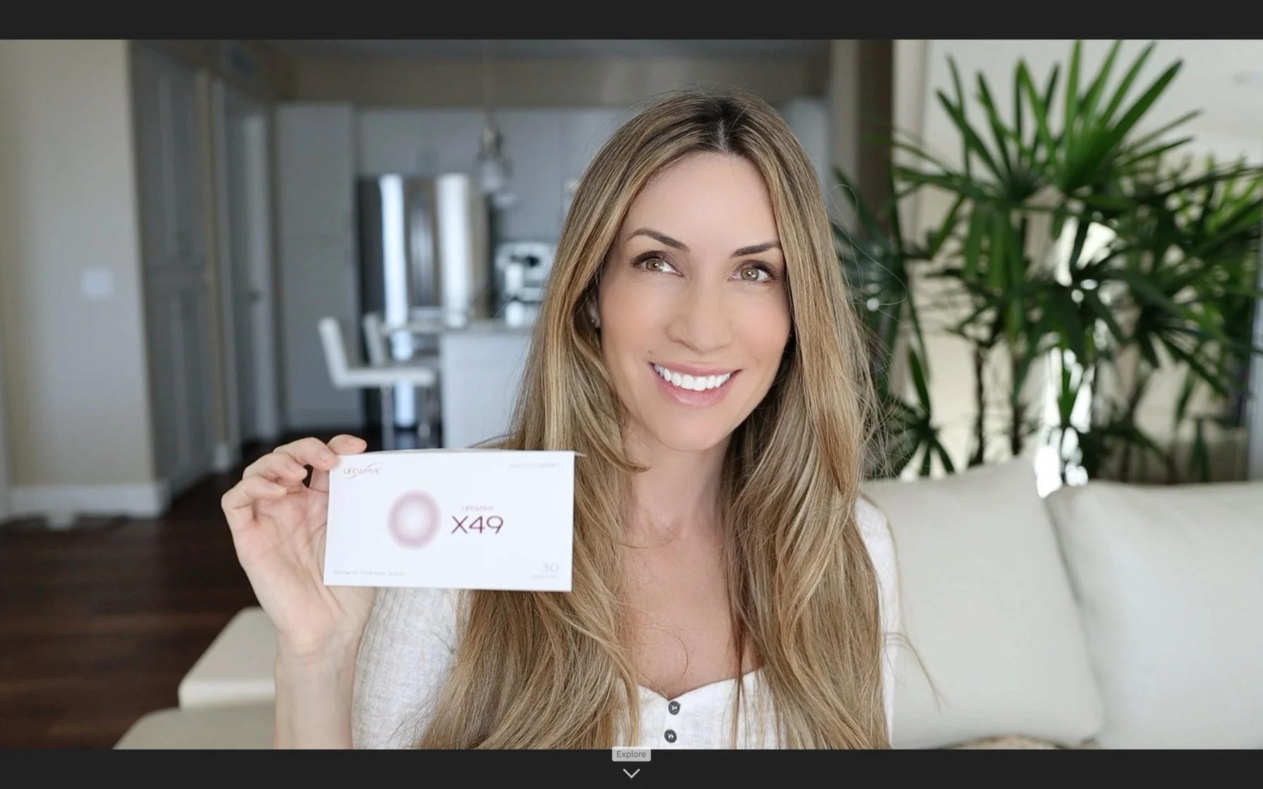Megan Graham holding an envelope of LifeWave patches and smiling