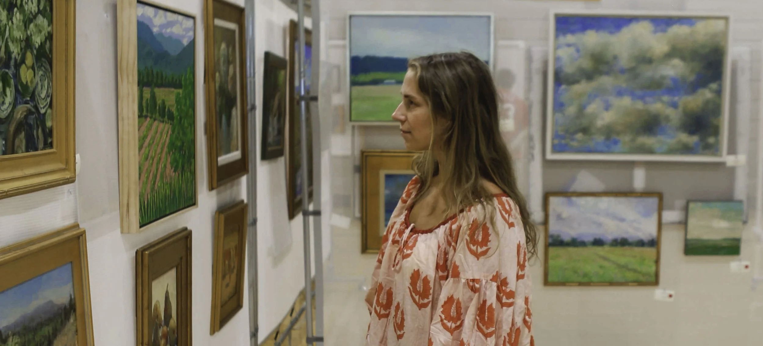 Paintings and mixed-media works hung along a gallery wall at The BEAR for 2026 A Second Look