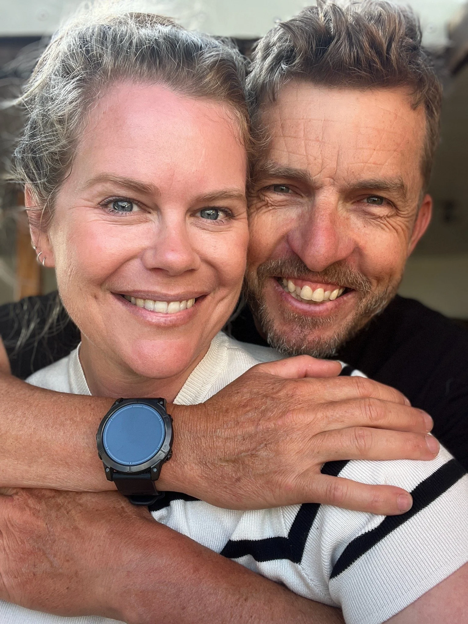 Tara Cooney and Jeff smiling together.