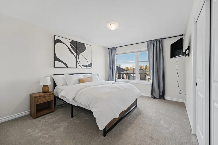 Bedroom with large windows at 687 Fisher Street, Kemptville