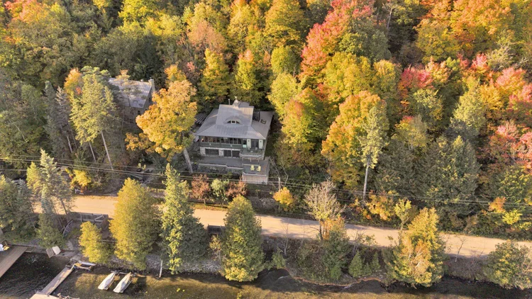 Aerial view of the waterfront home and wooded grounds at 755 Ch. du Lac-Meech, Chelsea