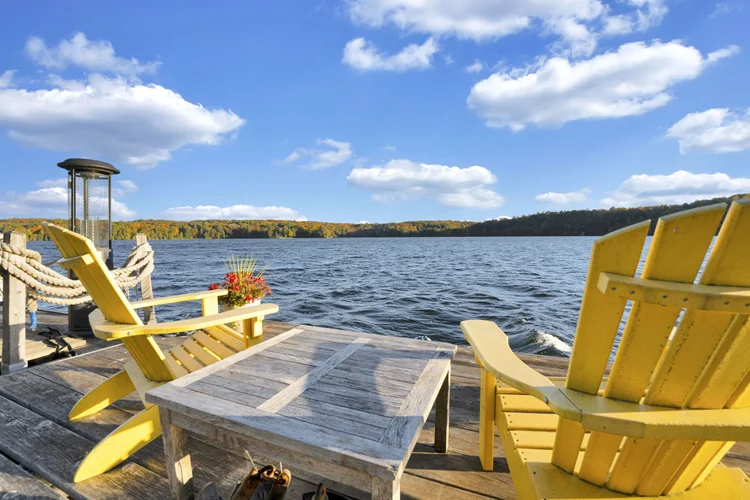 Yellow Adirondack chairs overlooking Meech Lake at 755 Ch. du Lac-Meech, Chelsea
