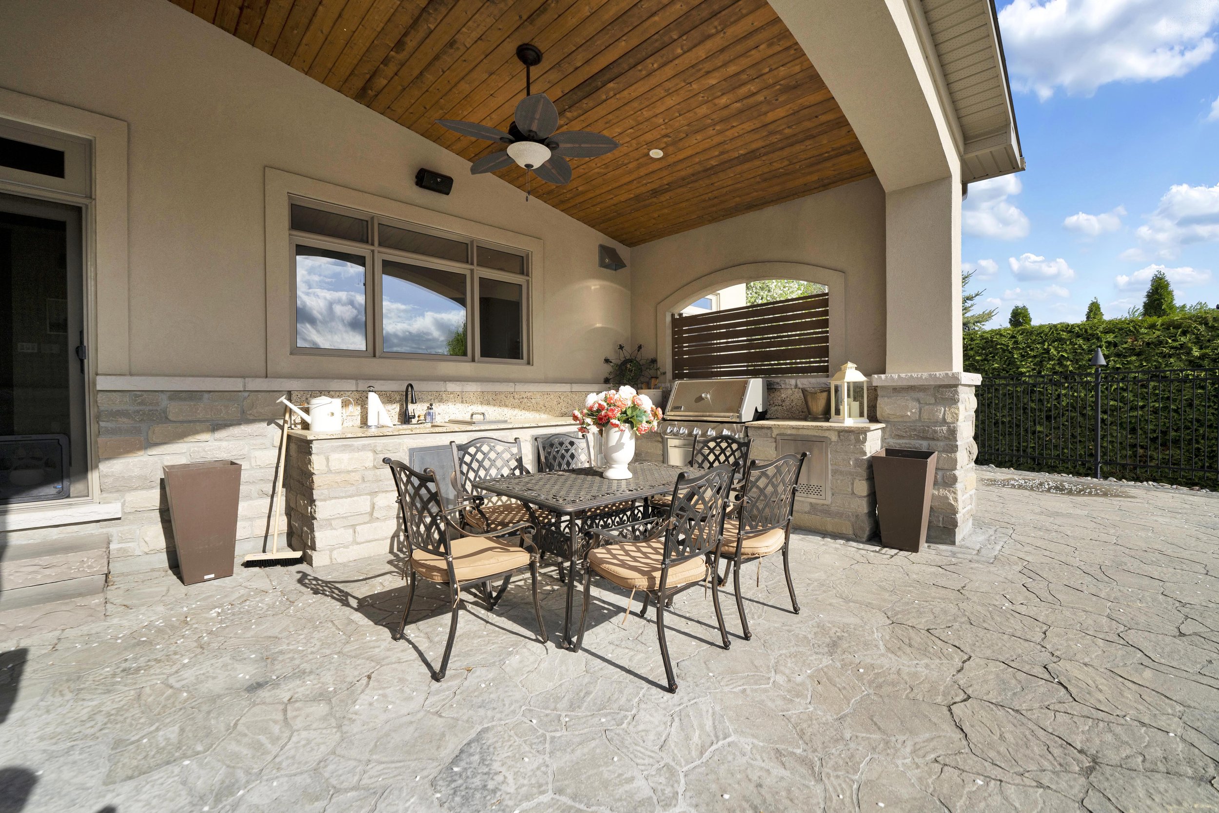 Covered terrace and outdoor fireplace at 812 McManus Avenue