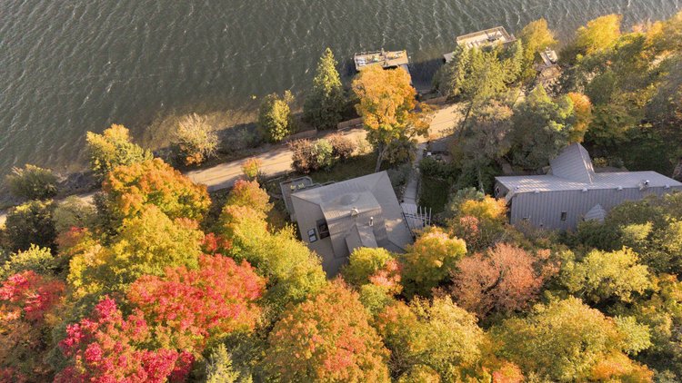 Aerial view of the waterfront home and wooded grounds at 755 Ch. du Lac-Meech, Chelsea