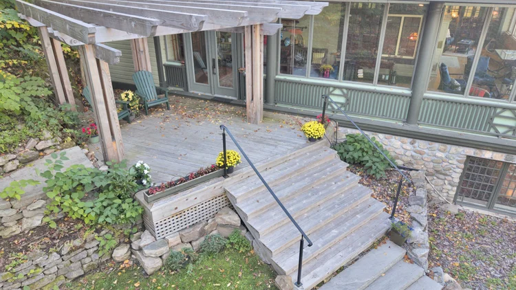 Aerial view of the waterfront home and wooded grounds at 755 Ch. du Lac-Meech, Chelsea