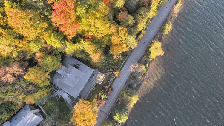 Aerial view of the waterfront home and wooded grounds at 755 Ch. du Lac-Meech, Chelsea