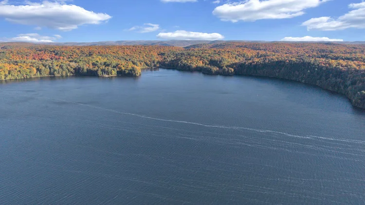 Aerial view of Meech Lake and autumn shoreline at 755 Ch. du Lac-Meech, Chelsea