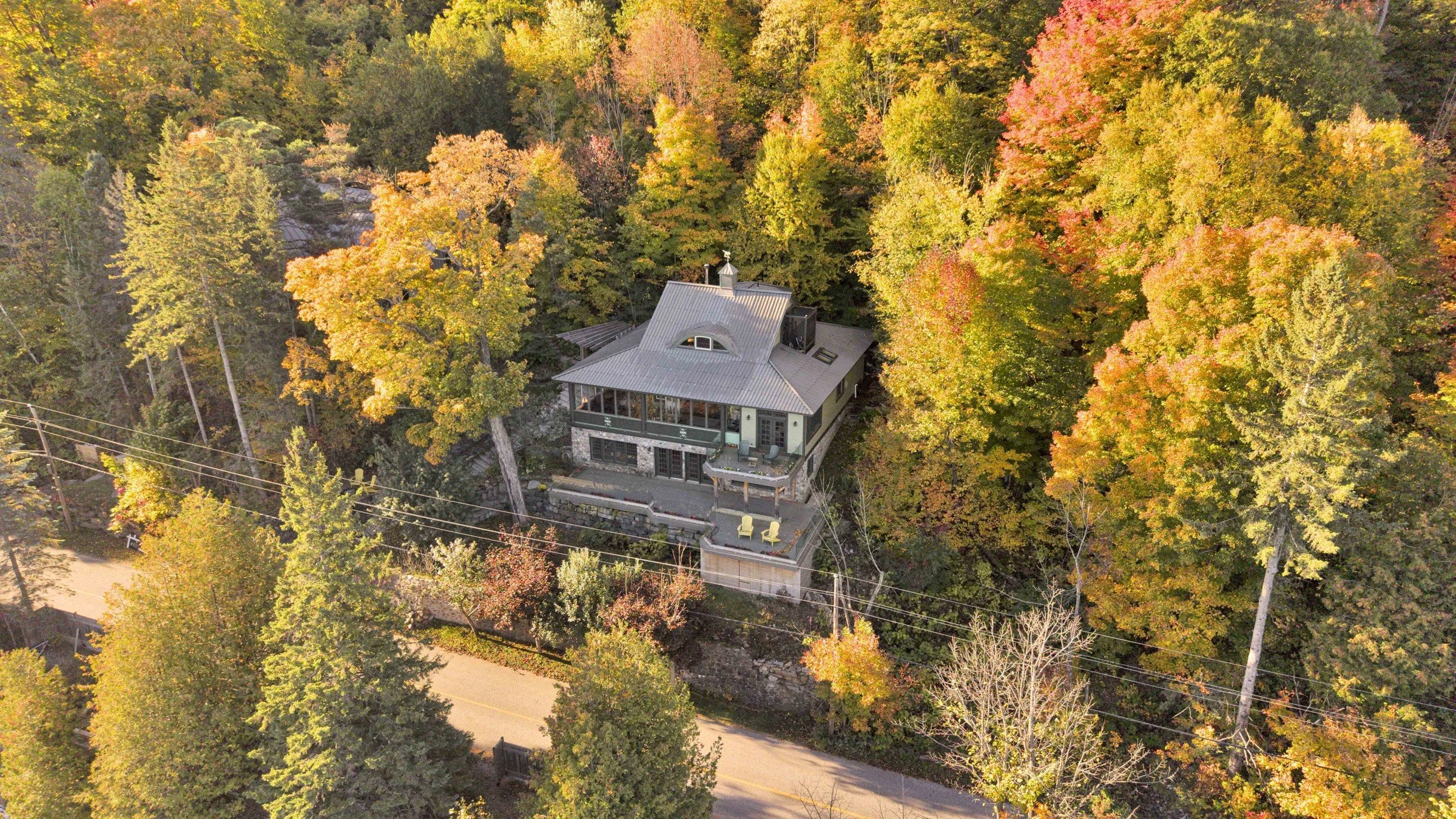 Aerial view of the waterfront home and wooded grounds at 755 Ch. du Lac-Meech, Chelsea