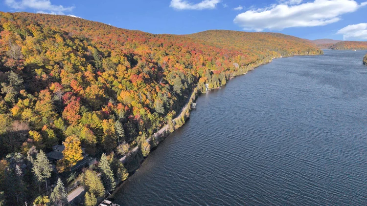 Aerial view of Meech Lake and autumn shoreline at 755 Ch. du Lac-Meech, Chelsea