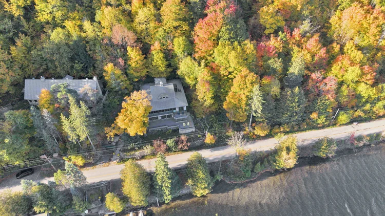 Aerial view of the waterfront home and wooded grounds at 755 Ch. du Lac-Meech, Chelsea