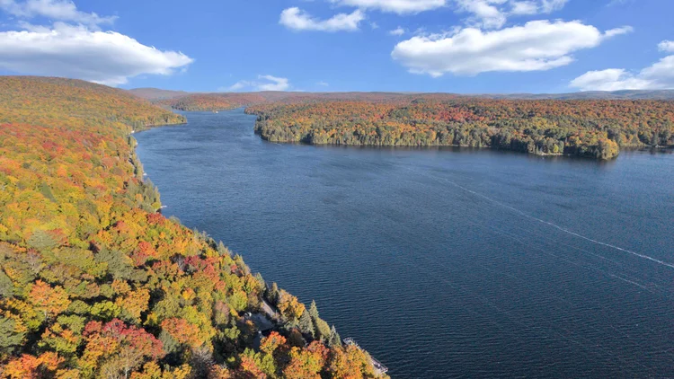 Aerial view of Meech Lake and autumn shoreline at 755 Ch. du Lac-Meech, Chelsea
