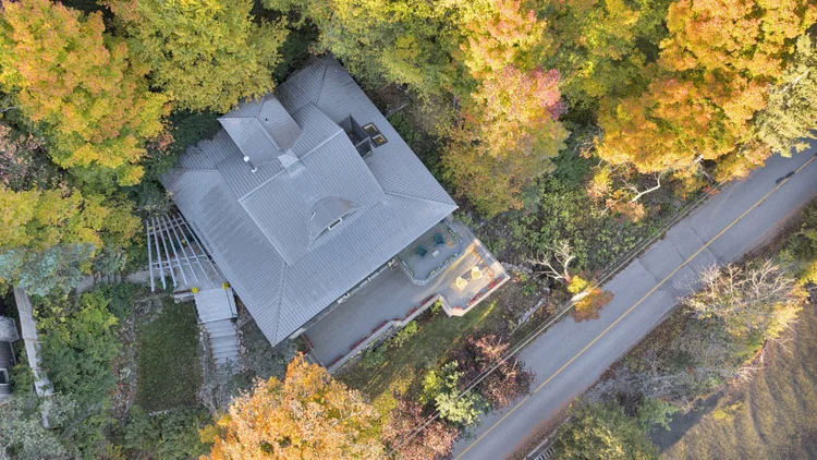 Aerial view of the waterfront home and wooded grounds at 755 Ch. du Lac-Meech, Chelsea