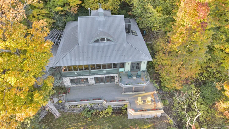 Aerial view of the waterfront home and wooded grounds at 755 Ch. du Lac-Meech, Chelsea