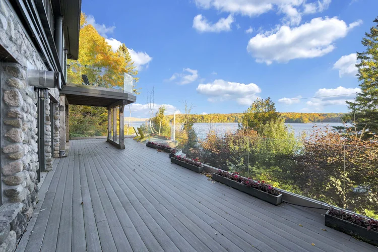 Exterior deck and wooded setting at 755 Ch. du Lac-Meech, Chelsea