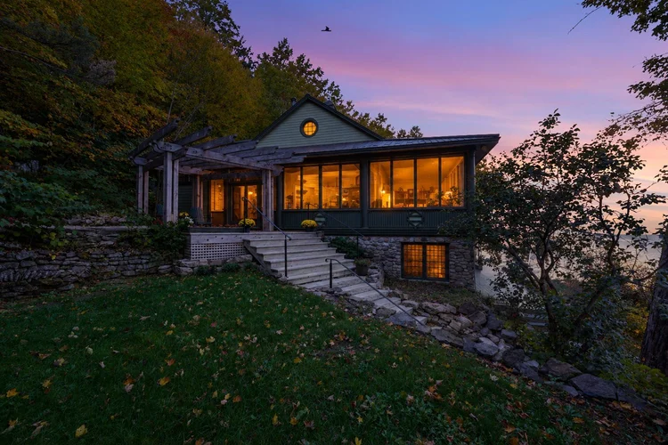 Lakeside home glowing at dusk at 755 Ch. du Lac-Meech, Chelsea