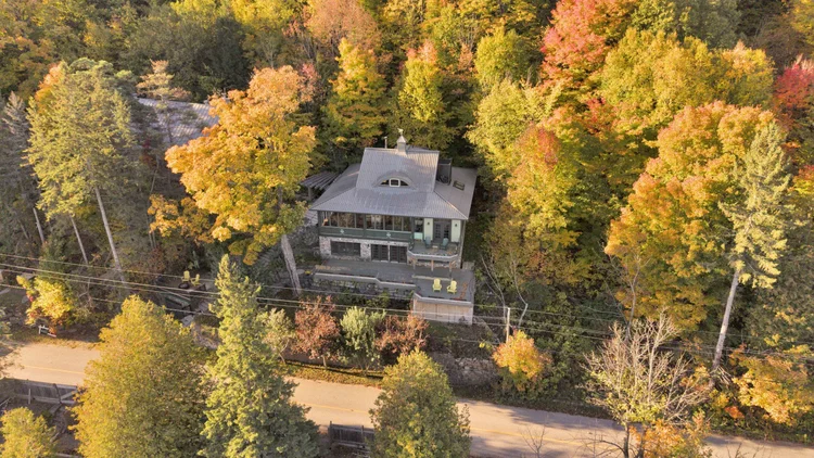 Aerial view of the waterfront home and wooded grounds at 755 Ch. du Lac-Meech, Chelsea