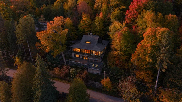 Aerial view of the waterfront home and wooded grounds at 755 Ch. du Lac-Meech, Chelsea