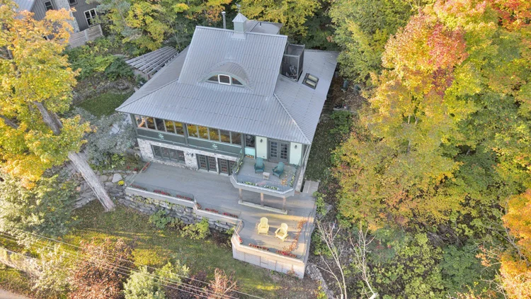 Aerial view of the waterfront home and wooded grounds at 755 Ch. du Lac-Meech, Chelsea