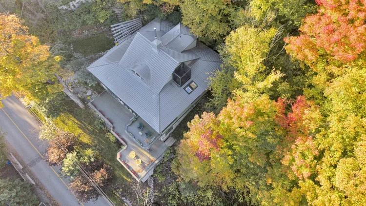 Aerial view of the waterfront home and wooded grounds at 755 Ch. du Lac-Meech, Chelsea