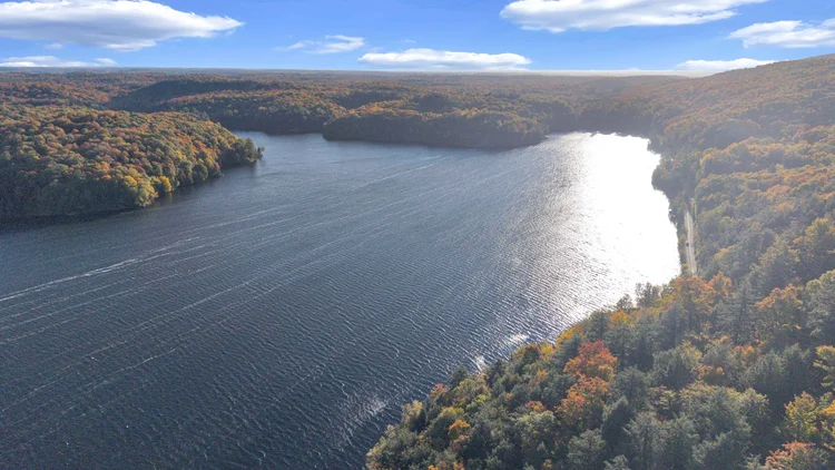 Aerial view of Meech Lake and autumn shoreline at 755 Ch. du Lac-Meech, Chelsea