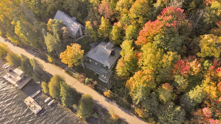Aerial view of the waterfront home and wooded grounds at 755 Ch. du Lac-Meech, Chelsea