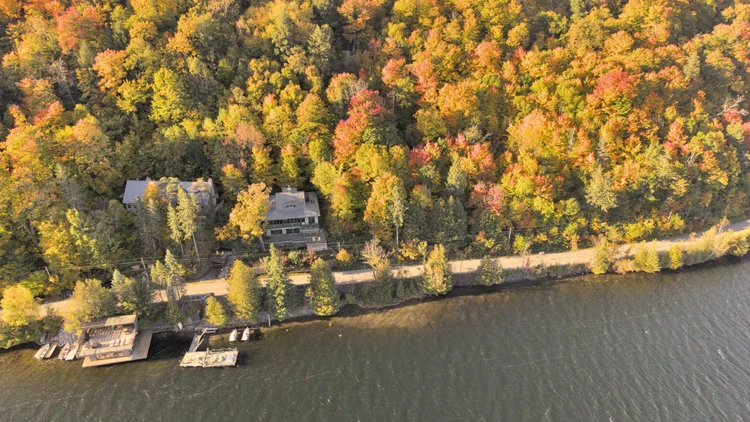 Aerial view of the waterfront home and wooded grounds at 755 Ch. du Lac-Meech, Chelsea