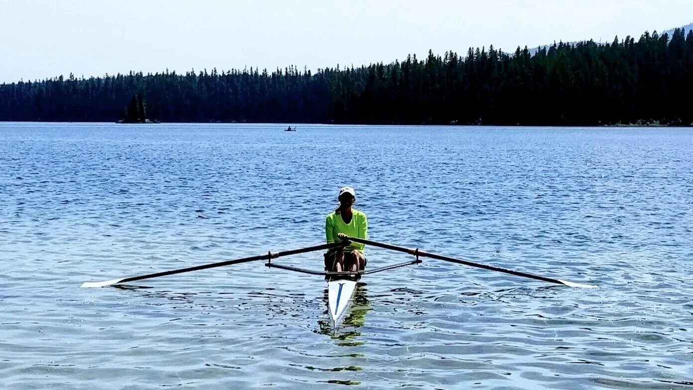 Christine Lustik sculling on a mountain lake in Montana