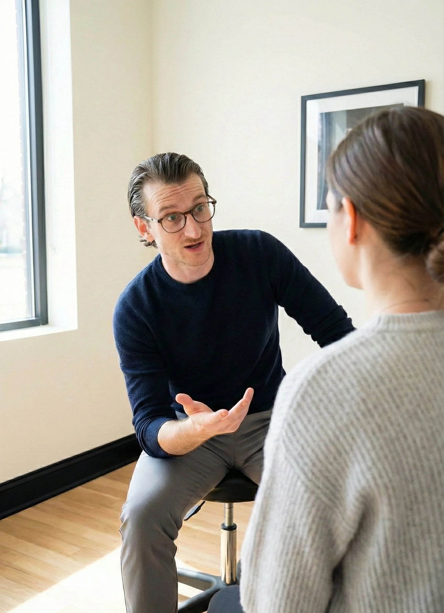 Dr. Jake in conversation with a patient at Optimize Chiropractic
