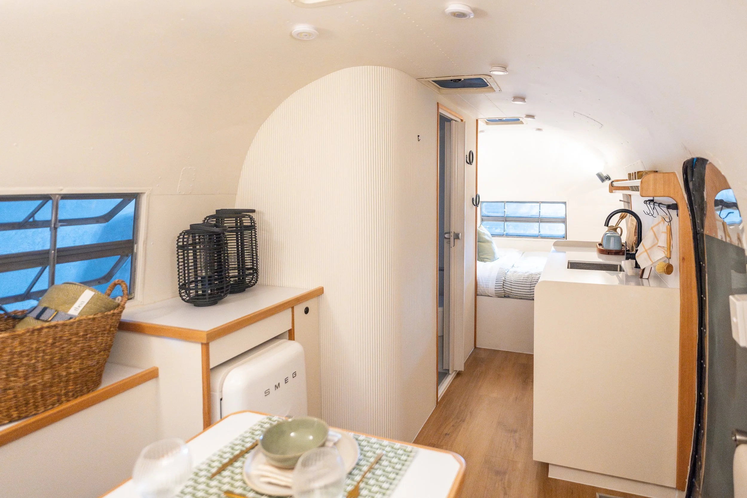 Flying Cloud living and dining area, central bathroom and kitchen, and bedroom beyond