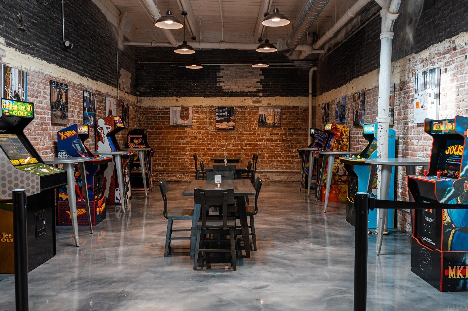 Classic arcade cabinets and tables in Burlington Beer Co.’s brick-walled arcade room